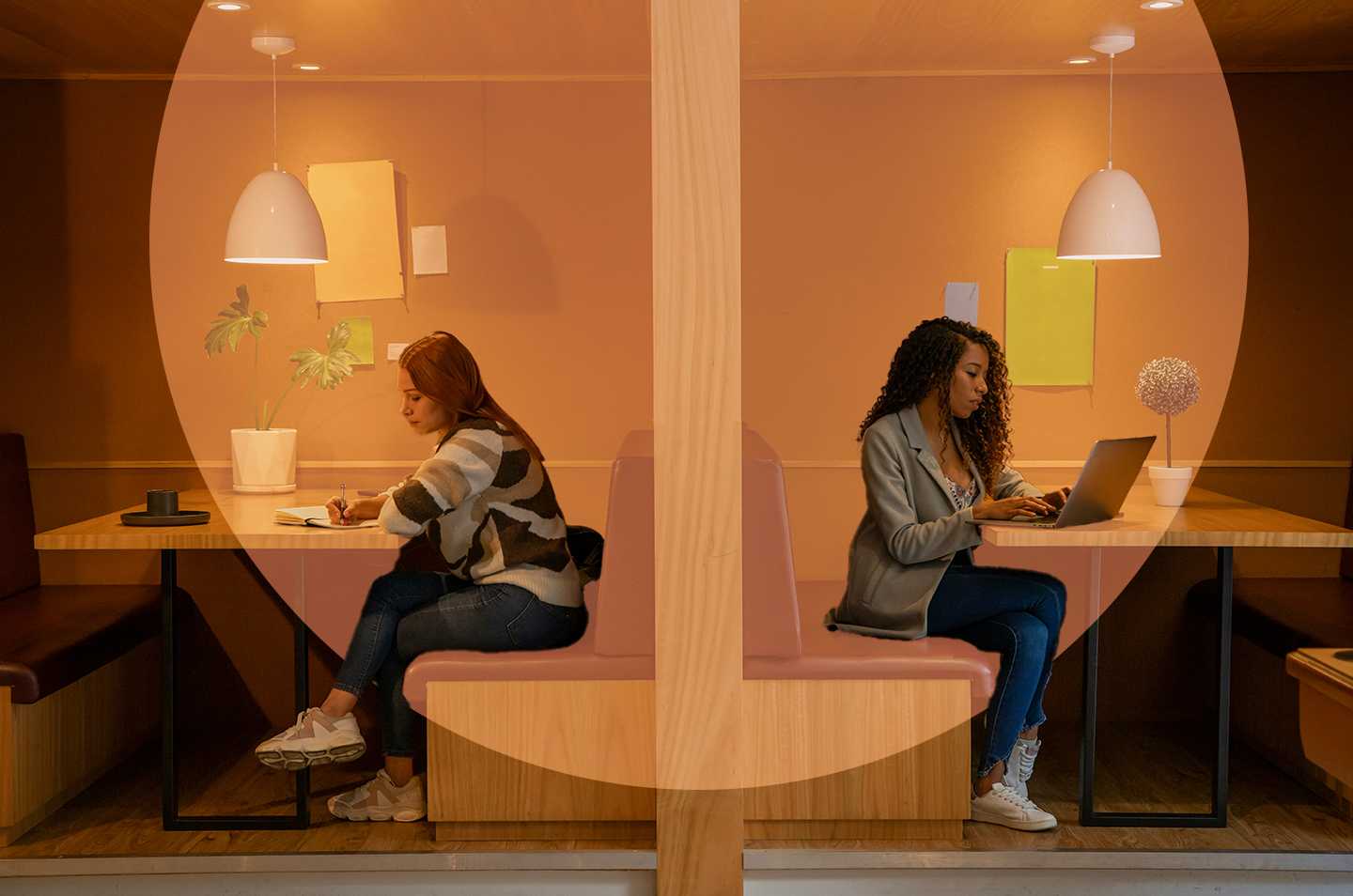 two women sitting in different booths facing opposite directions