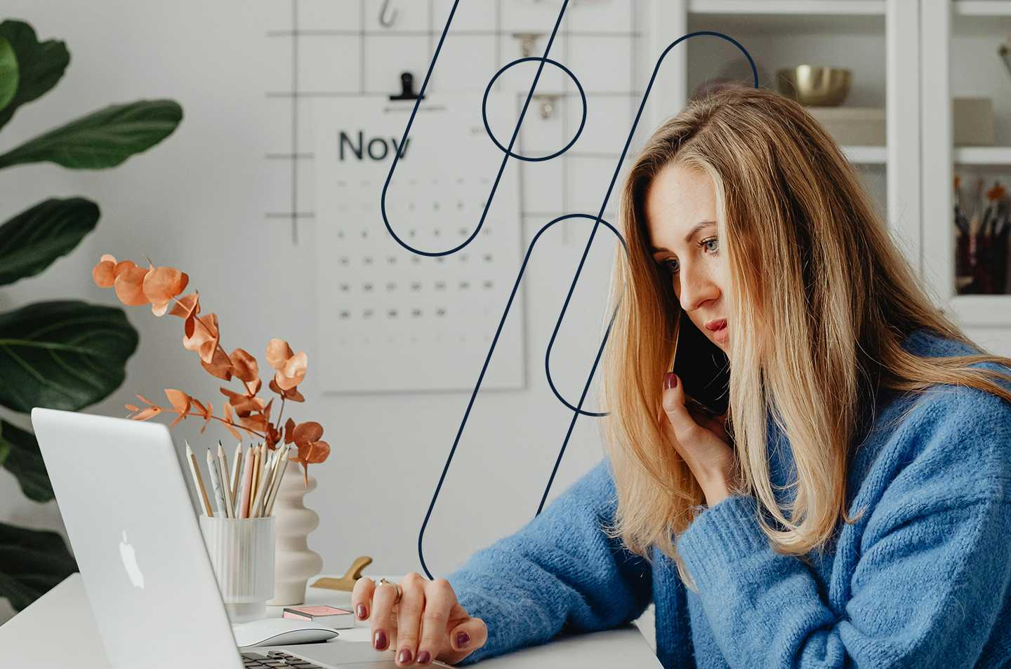 a woman sitting in front of a laptop on the phone