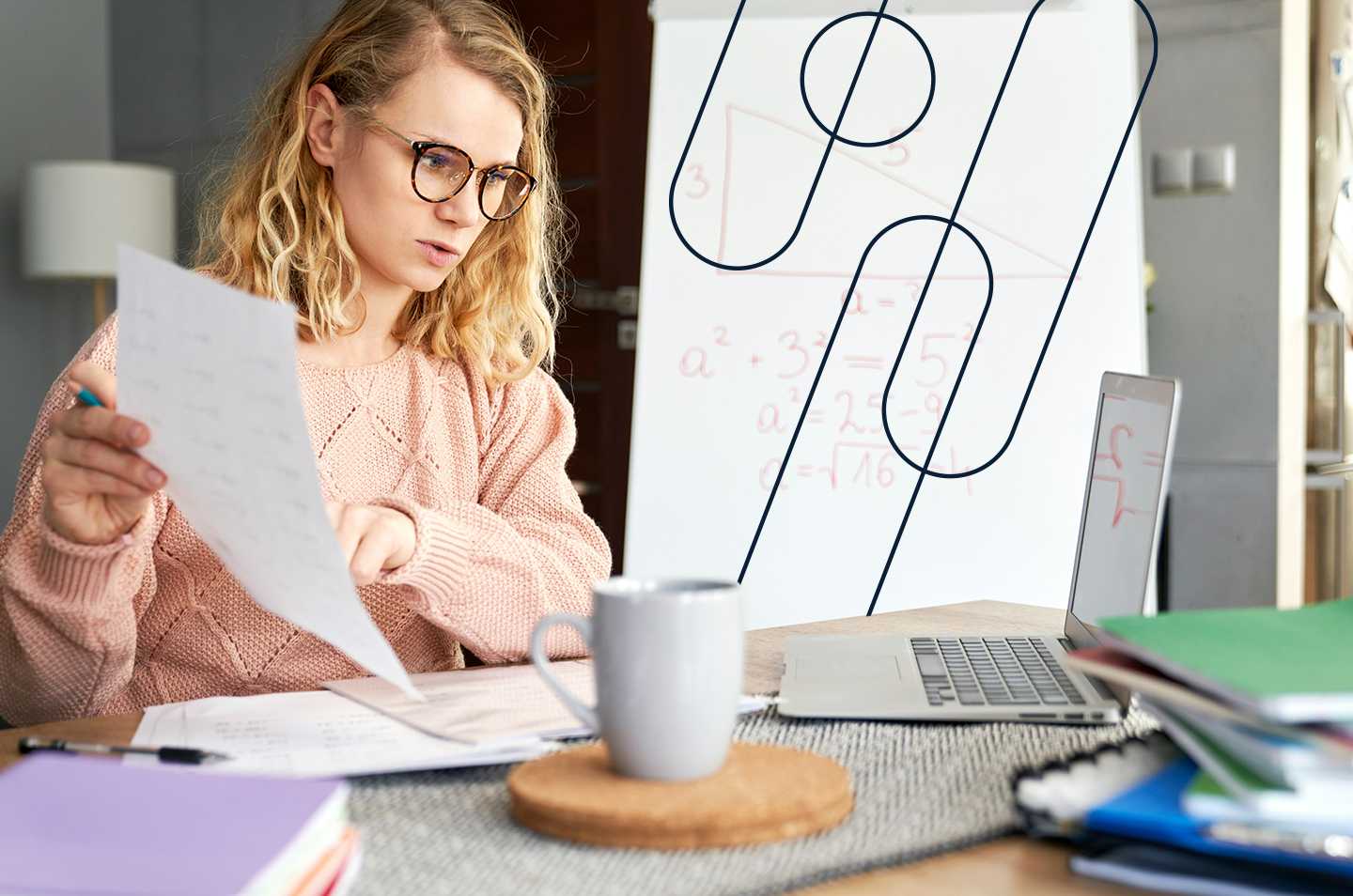 A woman with glasses holding up a piece of paper